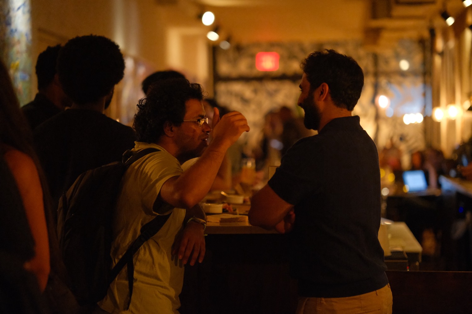 Guests talking over drinks at the bar