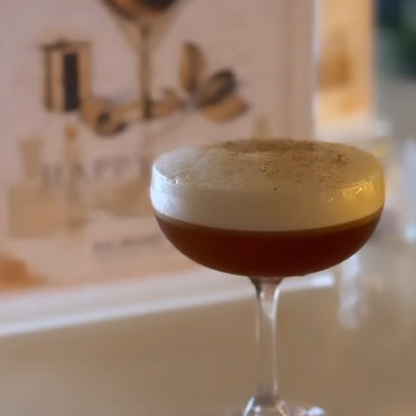 Non alcoholic Cocktail with foam in a glass against a blurred bar background